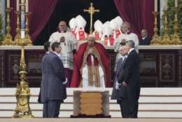Pope Francis sits by the coffin of late Pope Emeritus Benedict XVI in St. Peter's Square during a funeral mass at the Vatican, Thursday, Jan. 5, 2023.