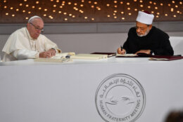 Pope Francis signs document pledging Christian-Muslim cooperation alongside Egypt's Azhar Grand Imam Sheikh Ahmed al-Tayeb.