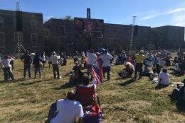 group of onlookers watch a screen